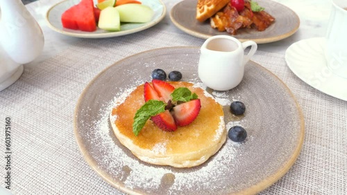 Wallpaper Mural Cozy cafe serving a delicious breakfast. Enjoy a sweet pastry, a cup of tea, and fresh fruits. Relaxed atmosphere of a cafe, perfect for any project related to food, leisure and morning routine. Torontodigital.ca