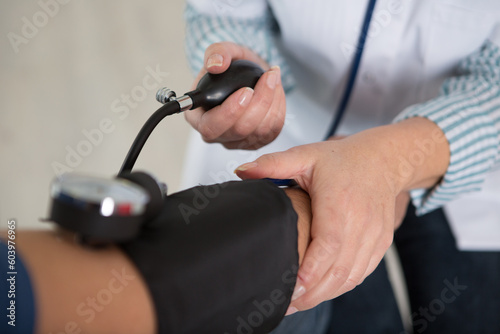 doctor woman checks blood pressure of patient