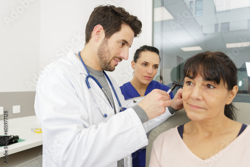 ent physician looking into patients ear with an instrument