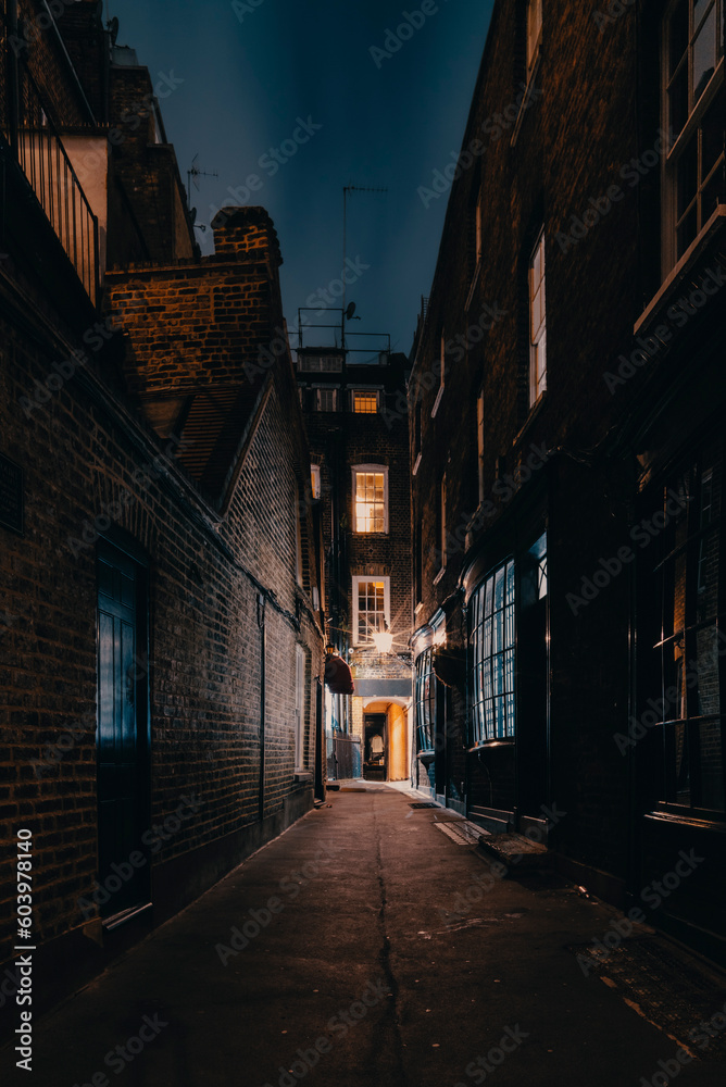 A mysterious and hidden old back alley in London at night