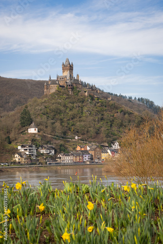 Cochem Castle or Reichsburg imperial impressive medieval historic building tower over old town with river Mosselle in German valley in Europe is popular landmark tourist attraction on sunnny day