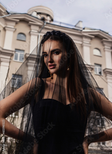 a woman in a Sicilian Italian look in a black dress