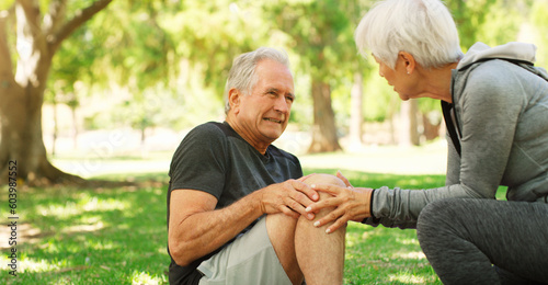Old couple, man with knee pain and injury outdoor, fibromyalgia health problem and joint ache from exercise. Woman helping, arthritis and people in retirement with fitness in park and mockup space © Sean A E/peopleimages.com