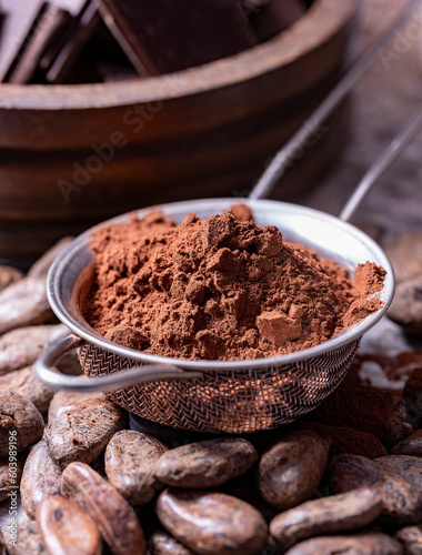 Powdered cocoa beans in a metal sieve