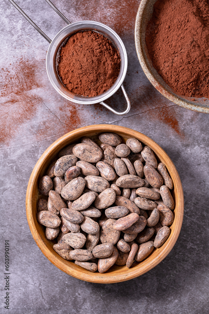 Whole cocoa beans placed on a wooden tray
