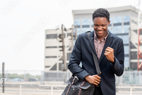 young african man feeling happy and celebrates photo