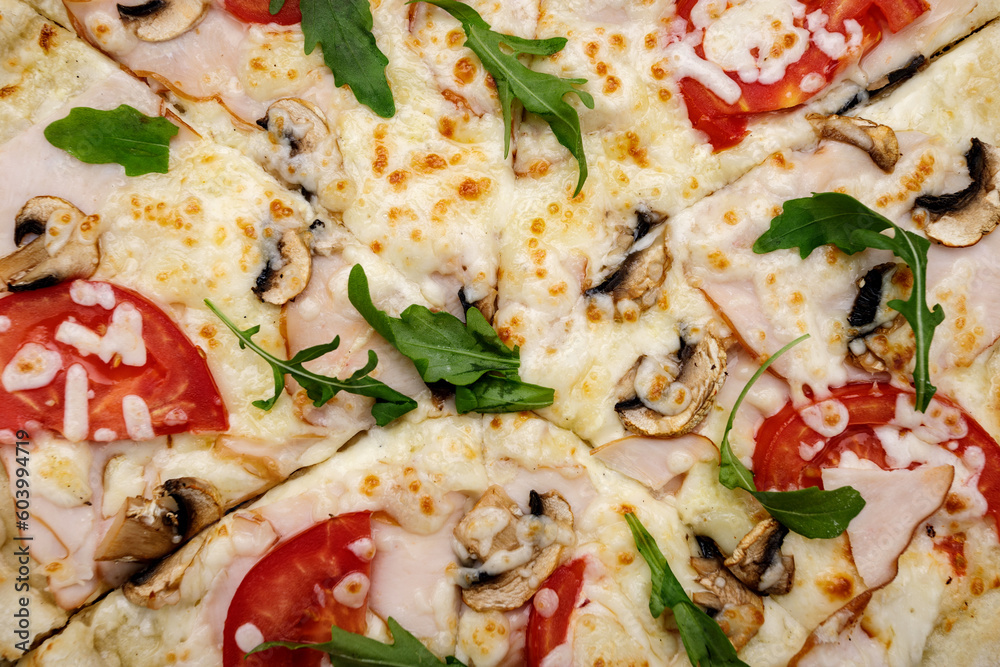 cheesy smoked meat pizza with tomatoes, arugula, and mushrooms, close-up cheesy smoked meat pizza with tomatoes, arugula, and mushrooms, close-up