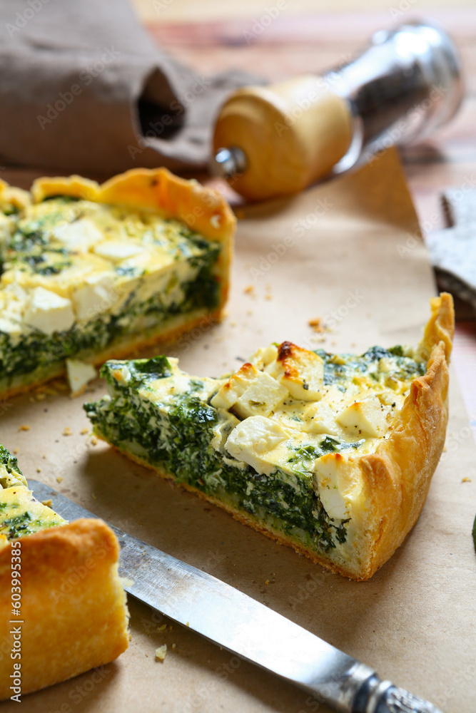 Sliced kale spinach feta pie on a napkin Sliced kale spinach feta pie on a napkin