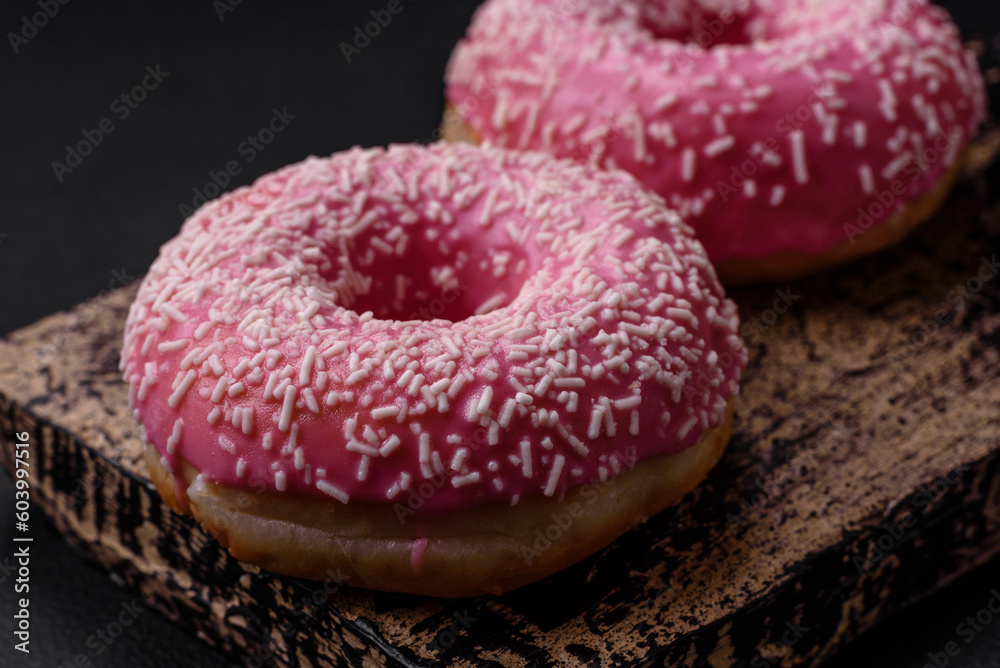 Delicious fresh sweet donuts in pink glaze with strawberry filling Delicious fresh sweet donuts in pink glaze with strawberry filling