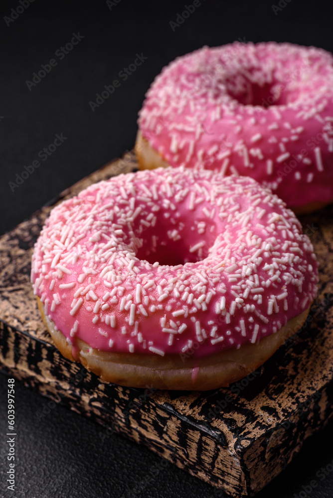 Delicious fresh sweet donuts in pink glaze with strawberry filling Delicious fresh sweet donuts in pink glaze with strawberry filling