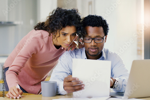 Couple, document and finance in budget planning, bills or expenses together in the kitchen at home. Serious man and woman person working on paperwork in financial, mortgage or investment strategy