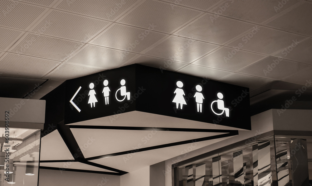 Symbols on black sign in mall near public toilet Symbols on black sign in mall near public toilet