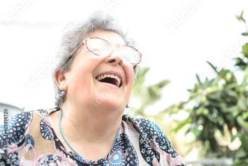 Grandmother with glasses and gray hair very happy smiling with denture
