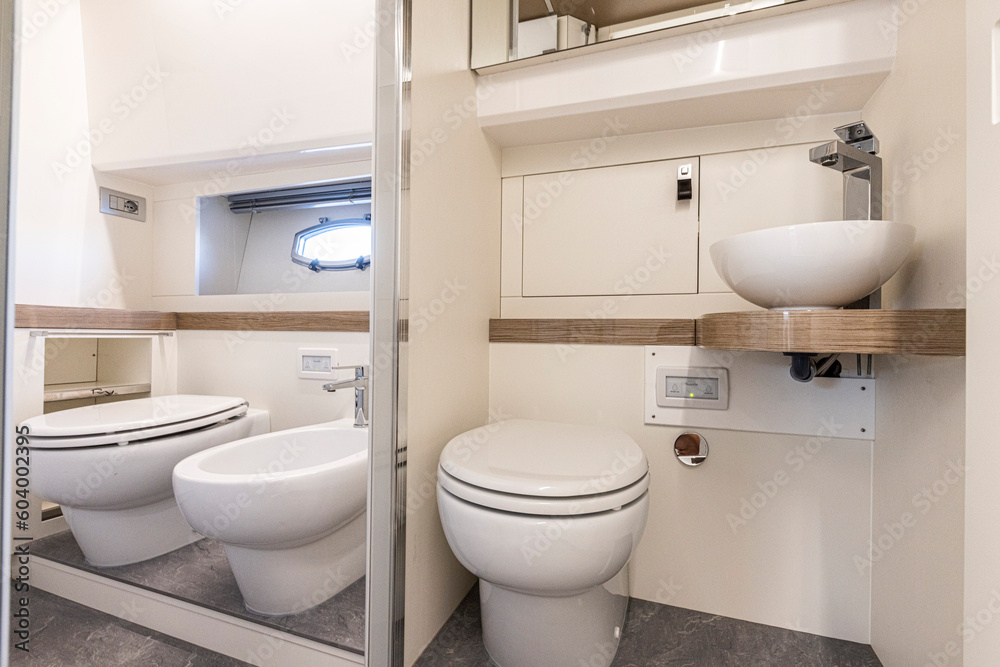 yacht Interior of a modern bathroom with white bathtub and toilet. Nobody inside yacht Interior of a modern bathroom with white bathtub and toilet. Nobody inside