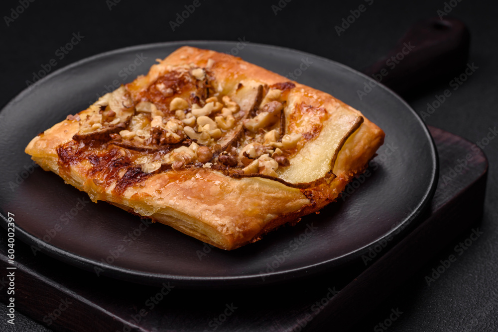 Delicious fresh sweet pie or pizza with pear, brie cheese, honey and nuts Delicious fresh sweet pie or pizza with pear, brie cheese, honey and nuts