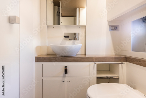 yacht Interior of a modern bathroom with white bathtub and toilet. Nobody inside