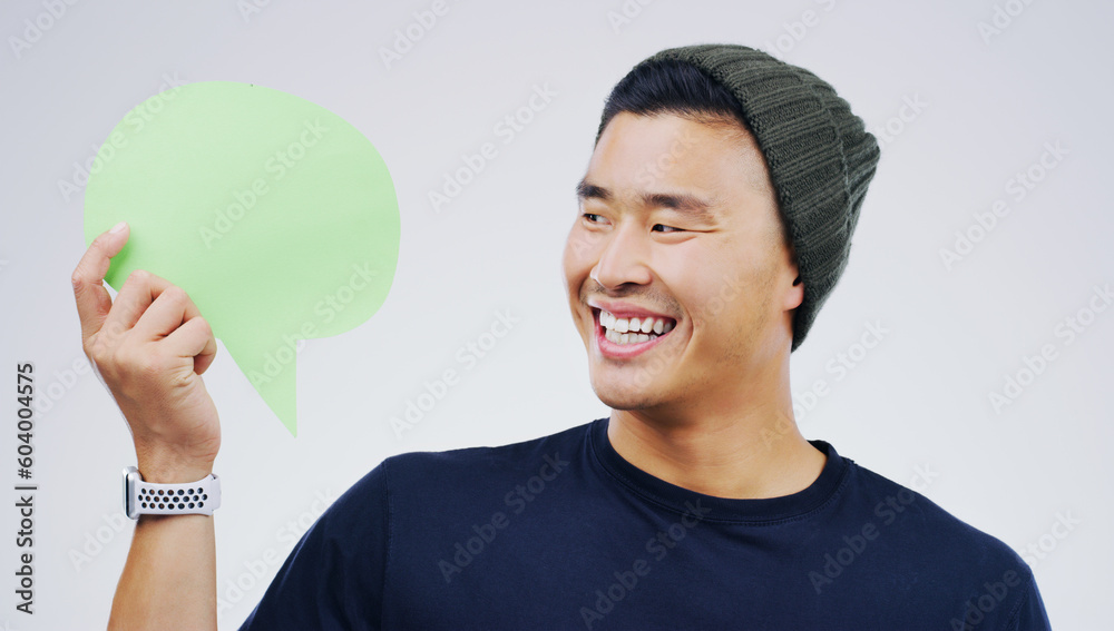 Young asian man, speech bubble and studio with smile, opinion and social media with by background. Gen z guy, poster or paper sign for vote, review or mockup with happiness for ideas, news or chat Young asian man, speech bubble and studio with smile, opinion and social media with by background. Gen z guy, poster or paper sign for vote, review or mockup with happiness for ideas, news or chat