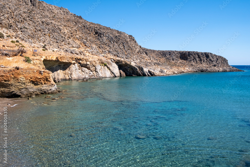 View of rocky coastline of Kato Zakros, transparent seabed with pebbles. Lasithi Province, Crete Greece 
