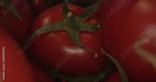 red tomatoes in wooden box and with laowa optics in the foreground in motion
