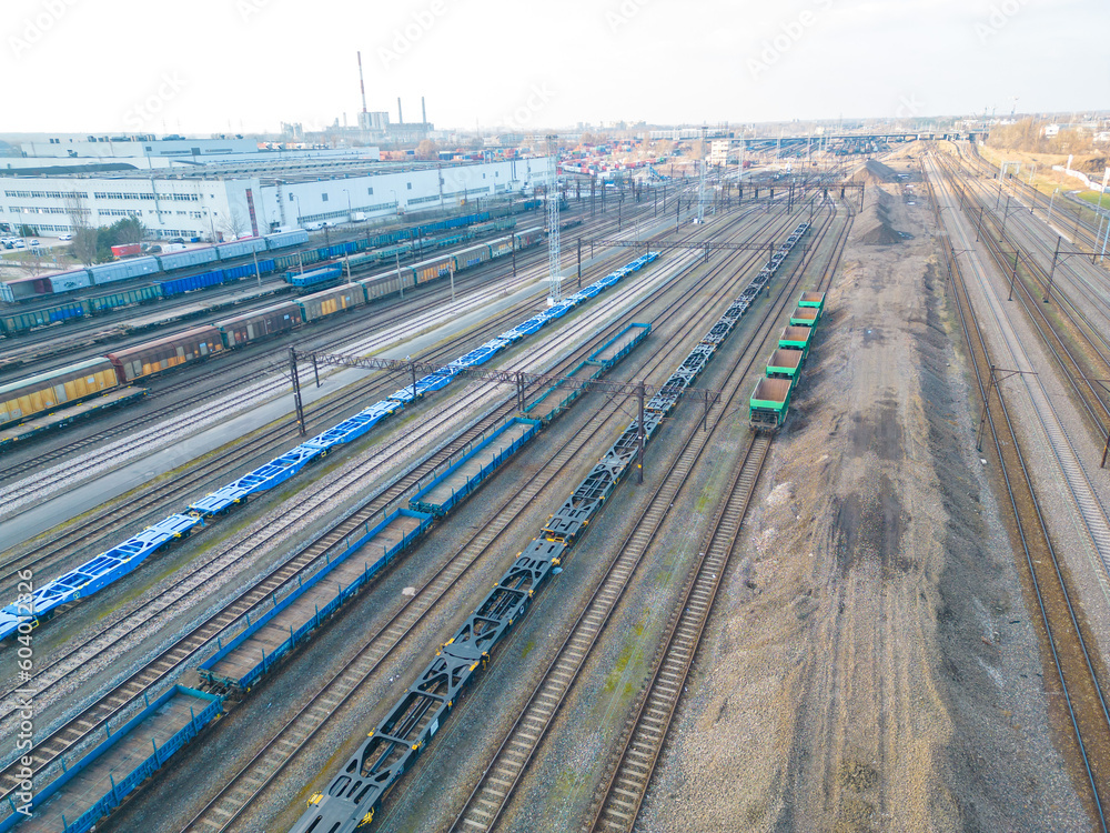 Cargo trains. Aerial view of colorful freight trains. Railway station. Wagons with goods on railroad. Heavy industry. Industrial scene with trains.Top view from drone