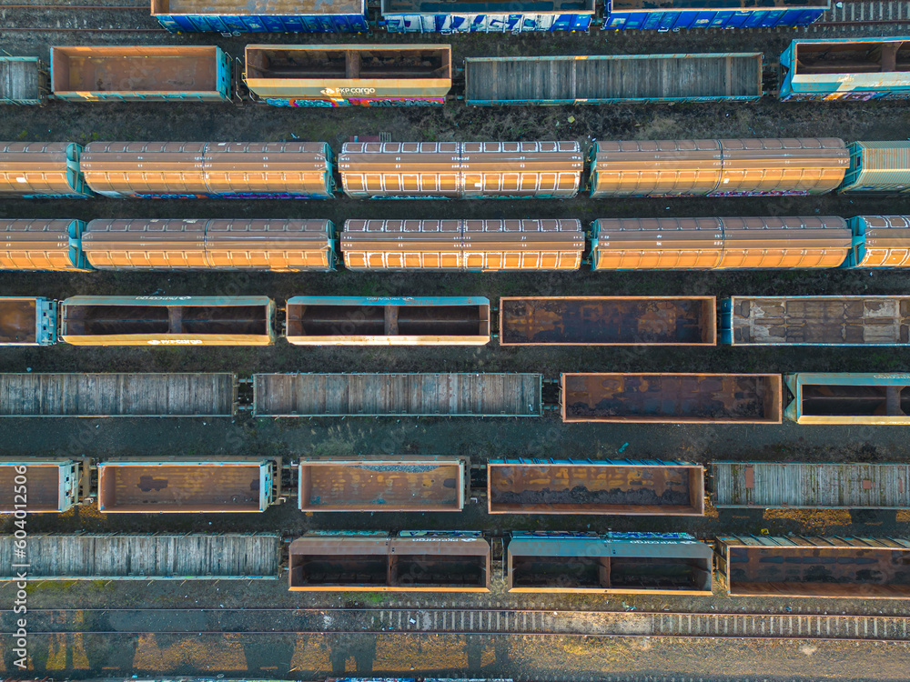 Cargo trains close-up. Aerial view of colorful freight trains on the railway station. Wagons with goods on railroad. Heavy industry. Industrial conceptual scene with trains. Top view from flying drone Cargo trains close-up. Aerial view of colorful freight trains on the railway station. Wagons with goods on railroad. Heavy industry. Industrial conceptual scene with trains. Top view from flying drone