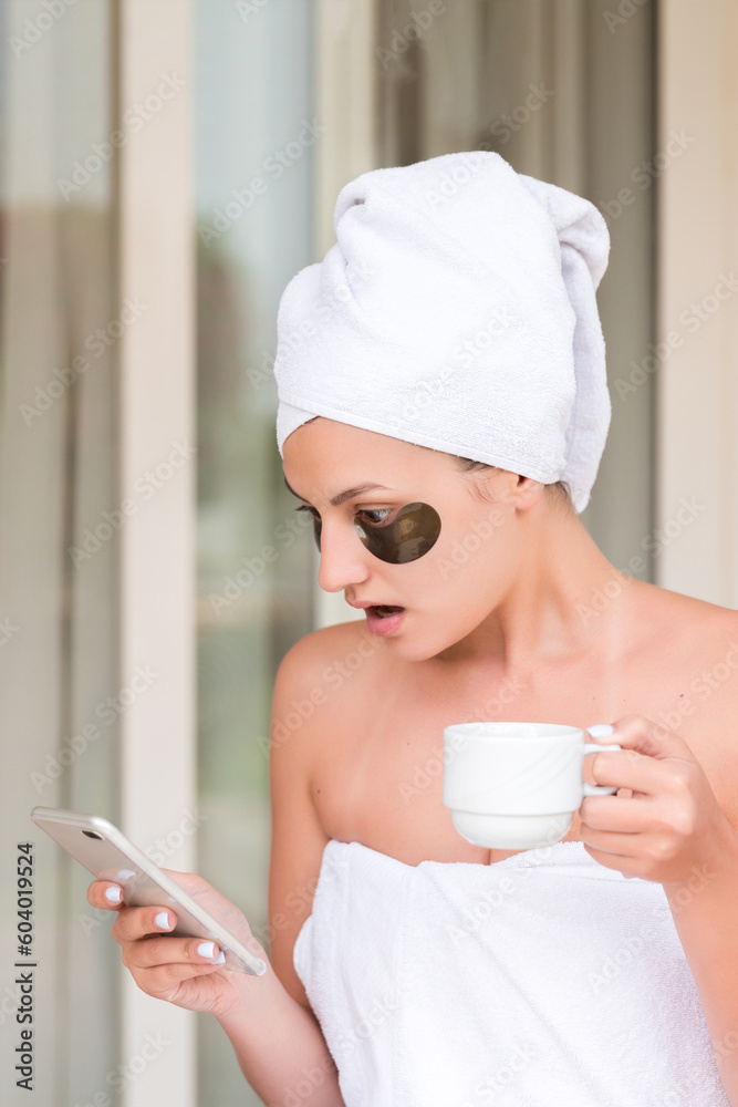 Shocked or surprised woman in under-eye patches reading message and drinking coffee at hotel terrace resort. morning holiday concept. bad news Shocked or surprised woman in under-eye patches reading message and drinking coffee at hotel terrace resort. morning holiday concept. bad news