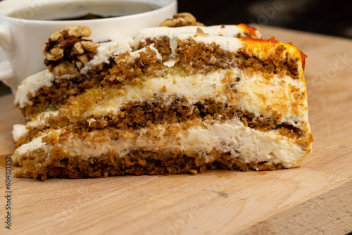 a cut piece of multi-layered honey cake with creamy filling