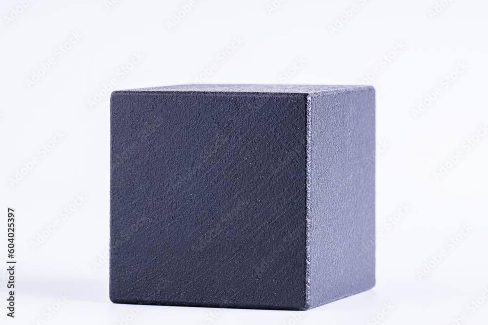Black wooden cube on white background. One black blank box, macro photo.