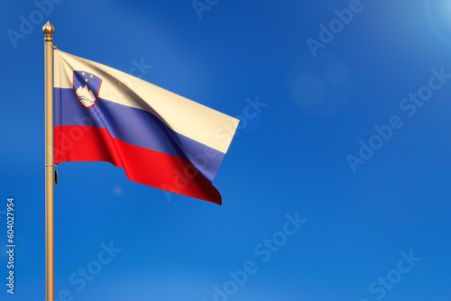 Slovenia. Flag blown by the wind with blue sky in the background.