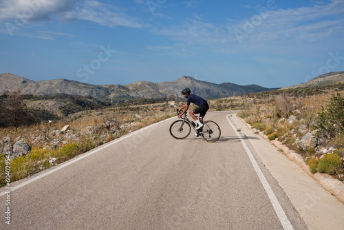 Pass Vall De Ebo.
Cyclist training on road bike in mountain.
Sport motivation.
Cycling holiday in Spain.