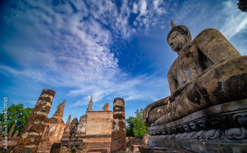 Wide view of sitting Buddha at sunset with blue sky and white cloud on background. UNESCO and World Heritage site. Travel concept.