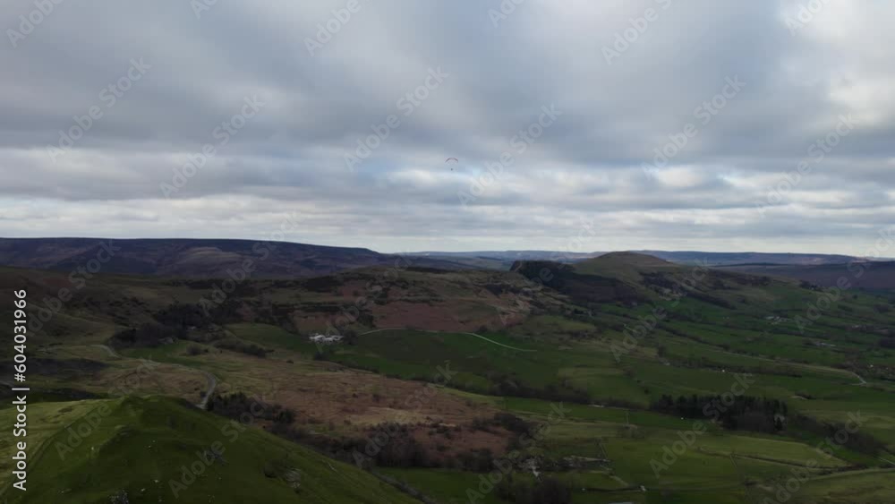 Winnats Pass, Peak District, UK 2022 - Flying up with a paraglider in the sky over the valley Winnats Pass, Peak District, UK 2022 - Flying up with a paraglider in the sky over the valley