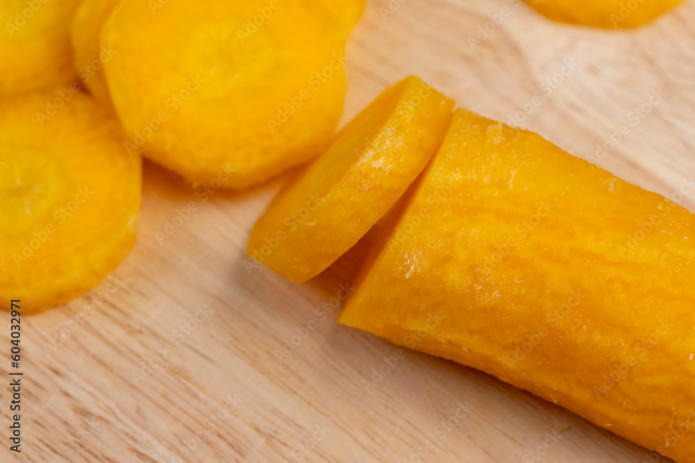 Sliced bright yellow carrots on the table Sliced bright yellow carrots on the table