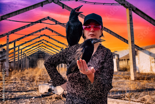 Young woman posing with a raven...
