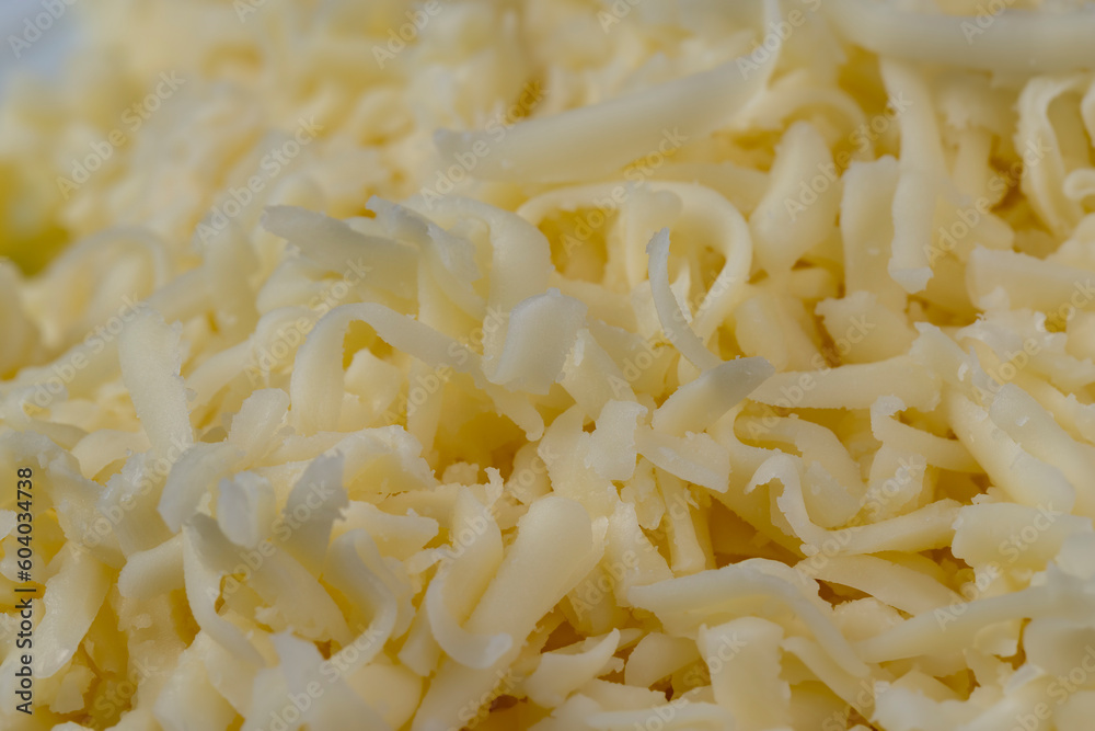 Hard cheese with holes grated into thin small slices Hard cheese with holes grated into thin small slices