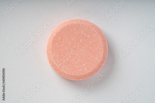 Close up of of chewable antacid acid reducer tablets with fruit flavor on white paper background photo