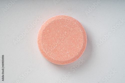 Close up of of chewable antacid acid reducer tablets with fruit flavor on white paper background