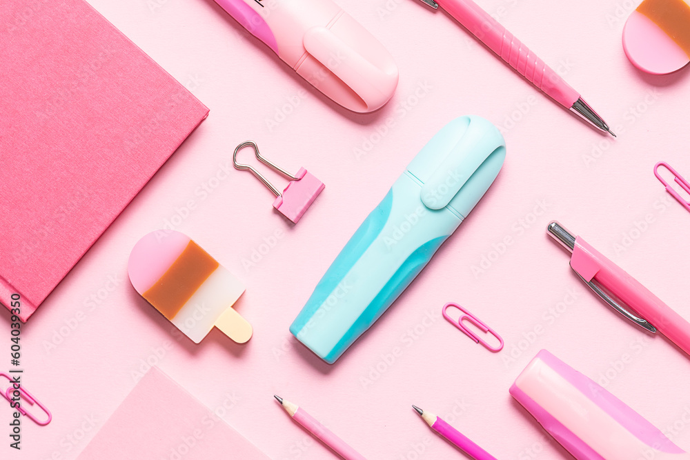 Pink stationery set on pink background and one blue marker pen top view. Concept of difference. Pink stationery set on pink background and one blue marker pen top view. Concept of difference.