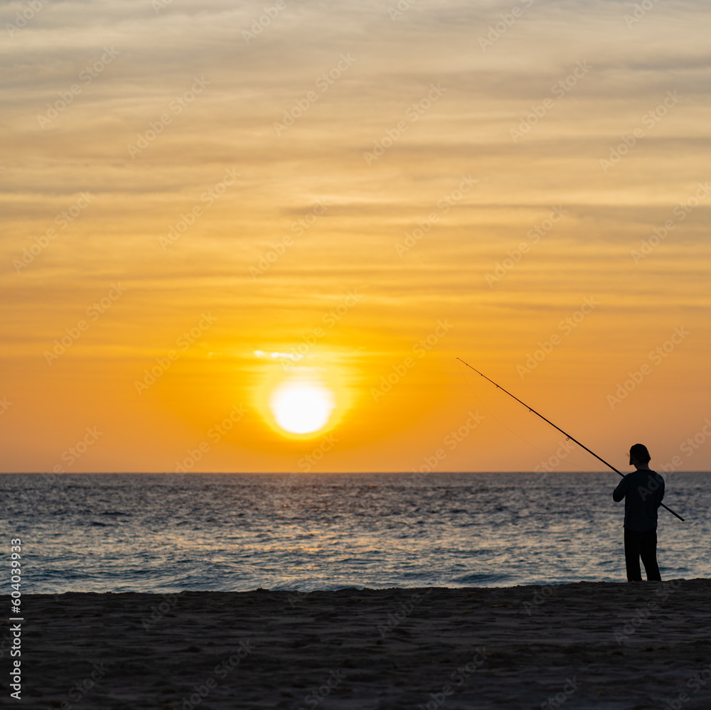 Sea fishing from the beach at sunset / sunrise.
