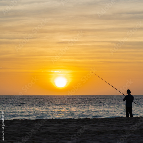 Sea fishing from the beach at sunset / sunrise.