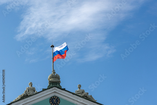 Russian flag on spire of the Winter Palace against sky in the center of St. Petersburg