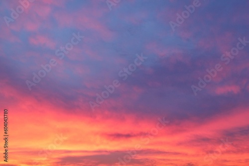 Twilight sunset sky. Nature background. Soft golden clouds. Sunrise early morning. Dramatic pastel panorama. Aerial view. Abstract landscape texture © Lidia