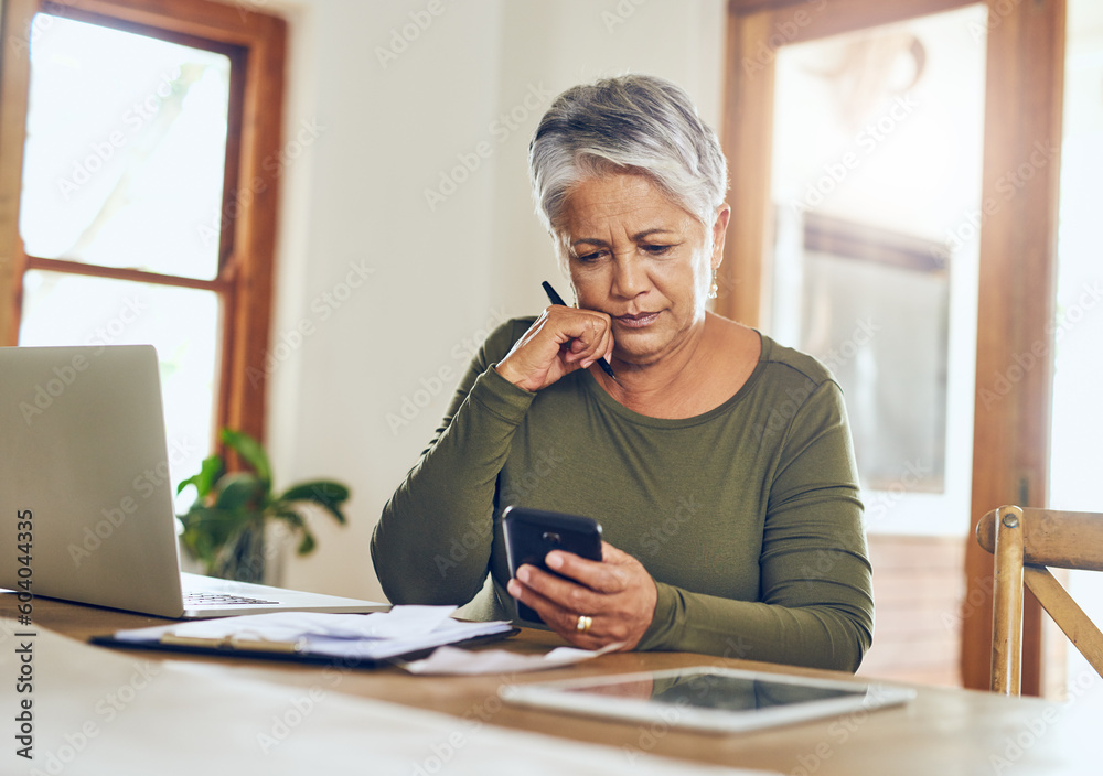 Obraz premium Senior woman, budget planning and mobile savings checklist with phone at home. Pension, contract and elderly female person with debt, online tax and paper form in a house with bills and web admin
