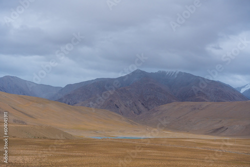 Landscape of Desert mountains against clouds sky at the way from Pangong Lake to Tso Moriri, Leh, Ladakh, Jammu and Kashmir, India
