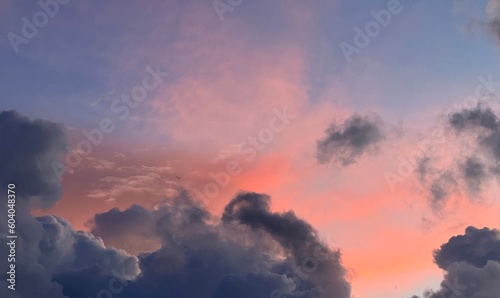 ovely fluffy pink orange purple blue and grey clouds in the sky above promthep cape Patong Kata Naiharn Surin beach Phuket Thailand at sunset