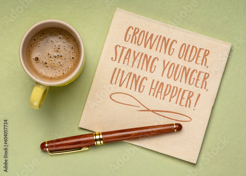growing older, staying younger, living happier - inspirational note on a napkin, healthy aging, lifestyle and personal development concept