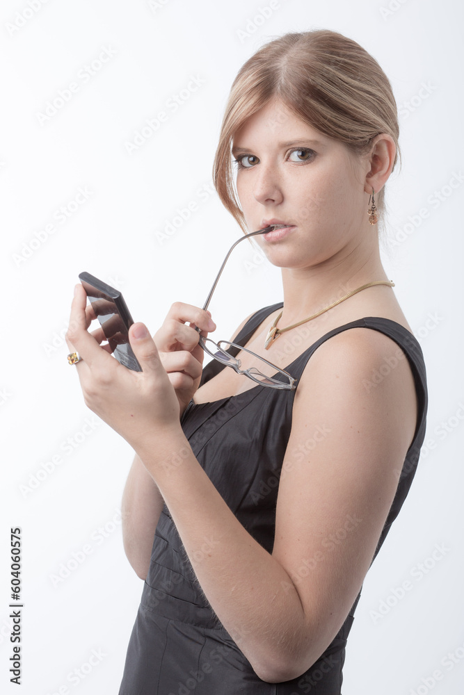 Young business woman is working with a calculator in front a bright white background Young business woman is working with a calculator in front a bright white background