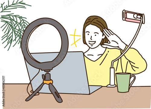 ノートパソコンで動画配信をする若い女性
