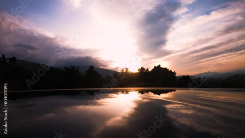 Moving cloud time-lapse showing reflection in sea at  time of sunrise and sunset