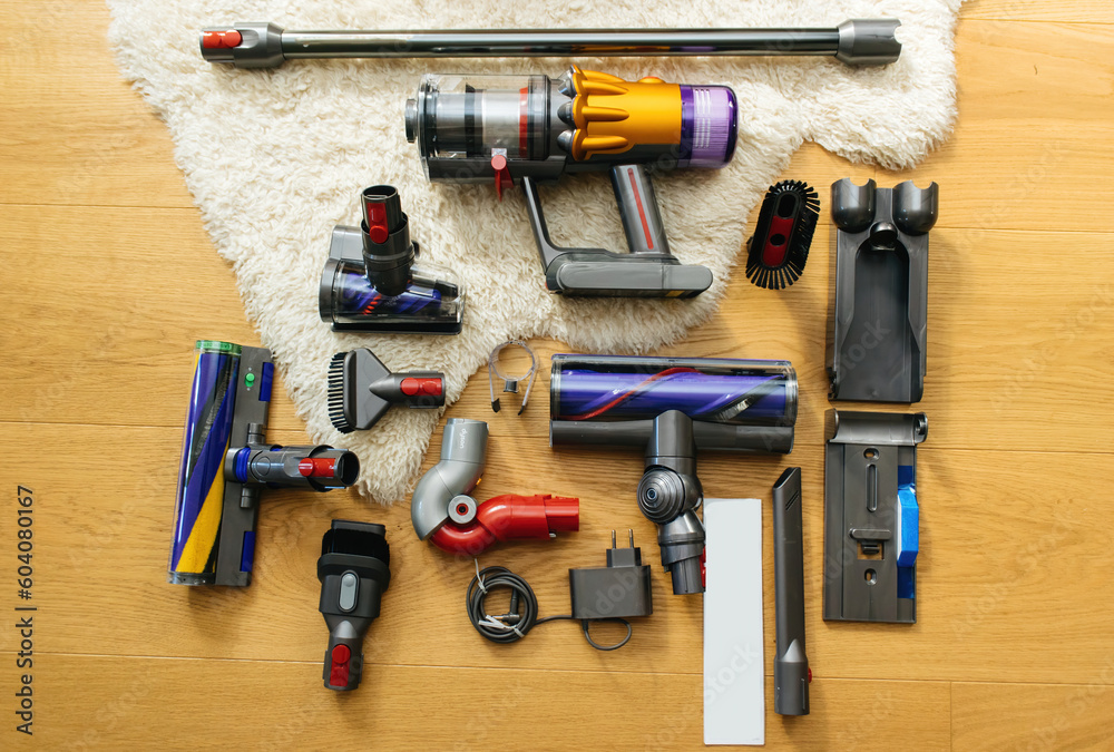 Knolling style above modern wireless Vacuum Cleaner powerful cordless colorful cyclonic dust collection - all accessories parts on the wooden parquet floor with Irish Sheepskin rug Knolling style above modern wireless Vacuum Cleaner powerful cordless colorful cyclonic dust collection - all accessories parts on the wooden parquet floor with Irish Sheepskin rug